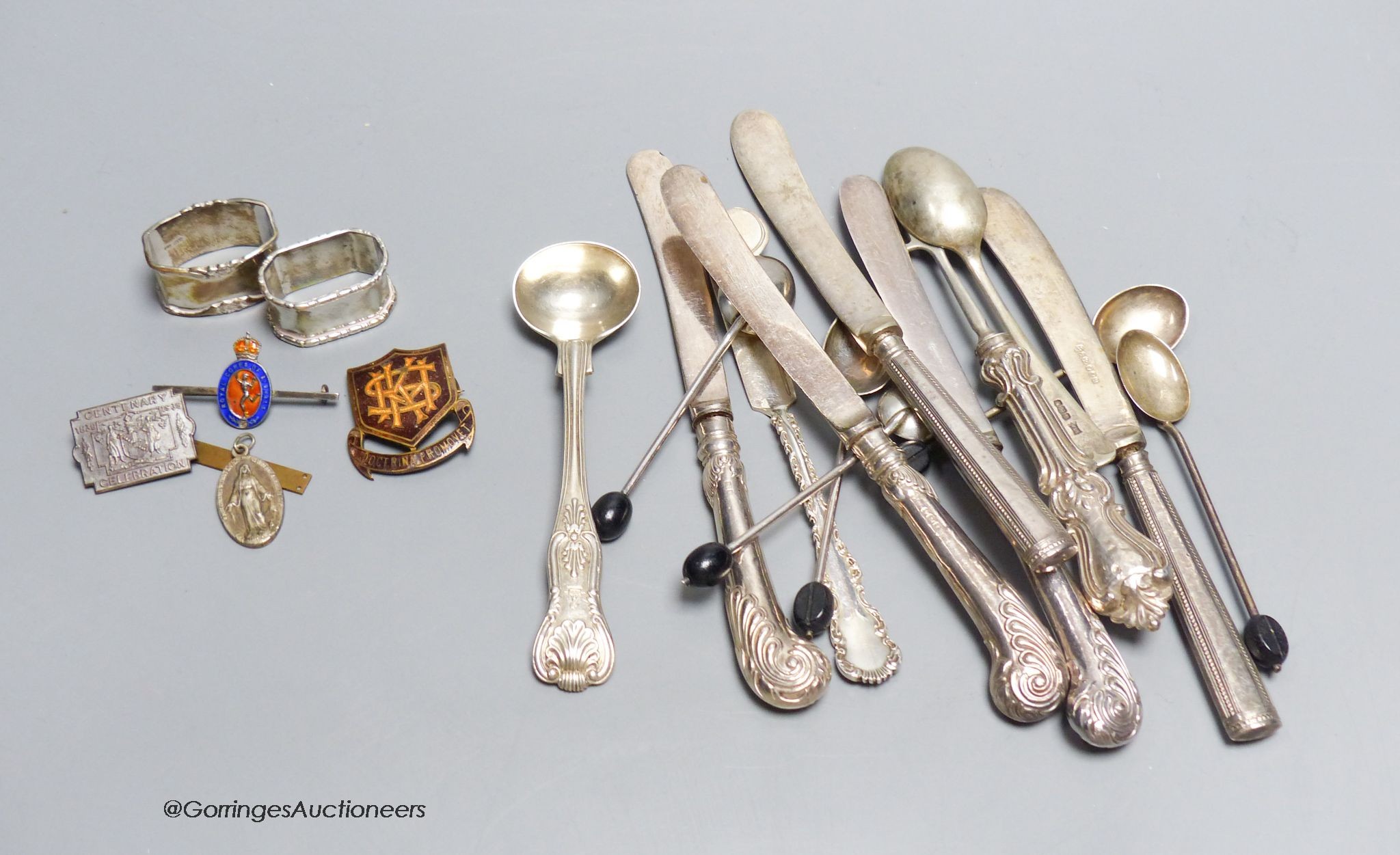 Six silver 'bean' handled coffee spoons, a Victorian silver mustard spoon, a butter knife, a pickle fork and other silver cutlery, a pair of scarf rings and four other items